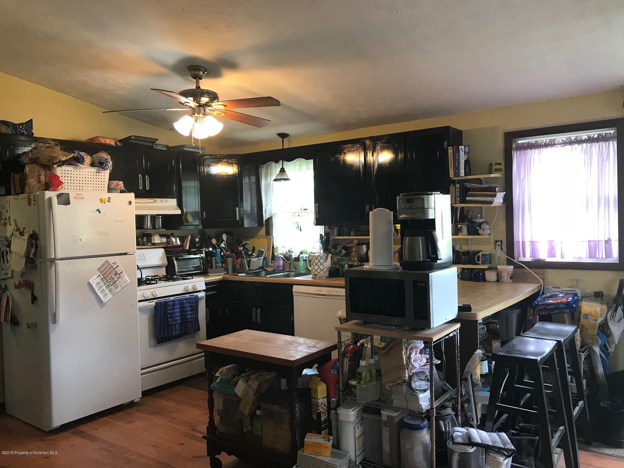 138 Pine Mill Road Honesdale, PA 18431 - Photo 12 of 54 a kitchen with a table chairs and refrigerator