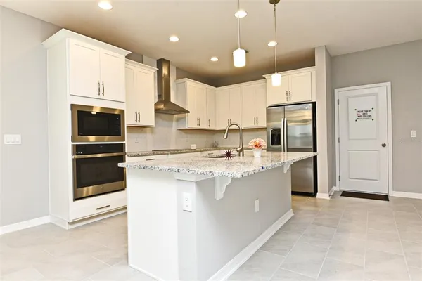 a bathroom with a granite countertop double vanity sink and mirror