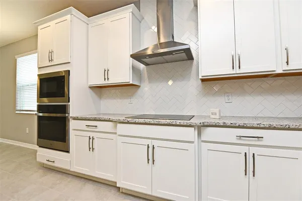 a close view of a refrigerator in kitchen and a window in the kitchen