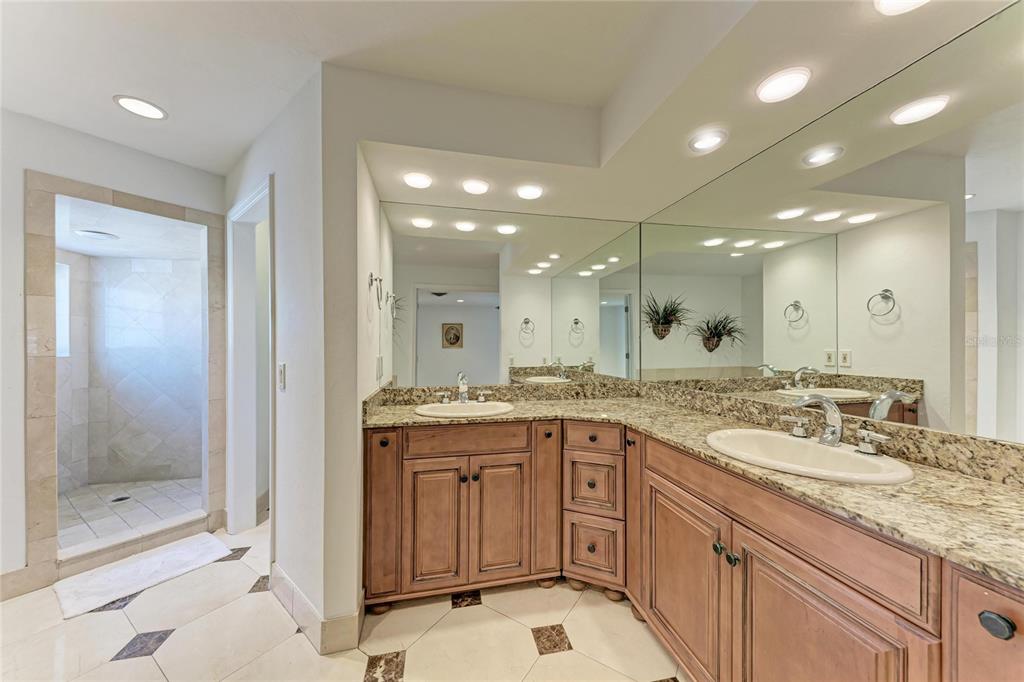3291 Bayou Road Longboat Key, FL 34228 - Photo 13 of 41 a bathroom with a granite countertop sink mirror and shower