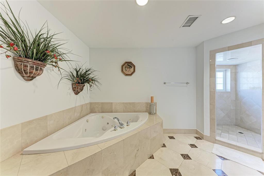 3291 Bayou Road Longboat Key, FL 34228 - Photo 14 of 41 a bathroom with a bathtub and a shower