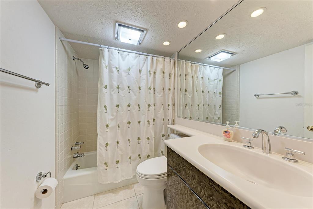 3291 Bayou Road Longboat Key, FL 34228 - Photo 18 of 41 a bathroom with a double vanity sink toilet and shower