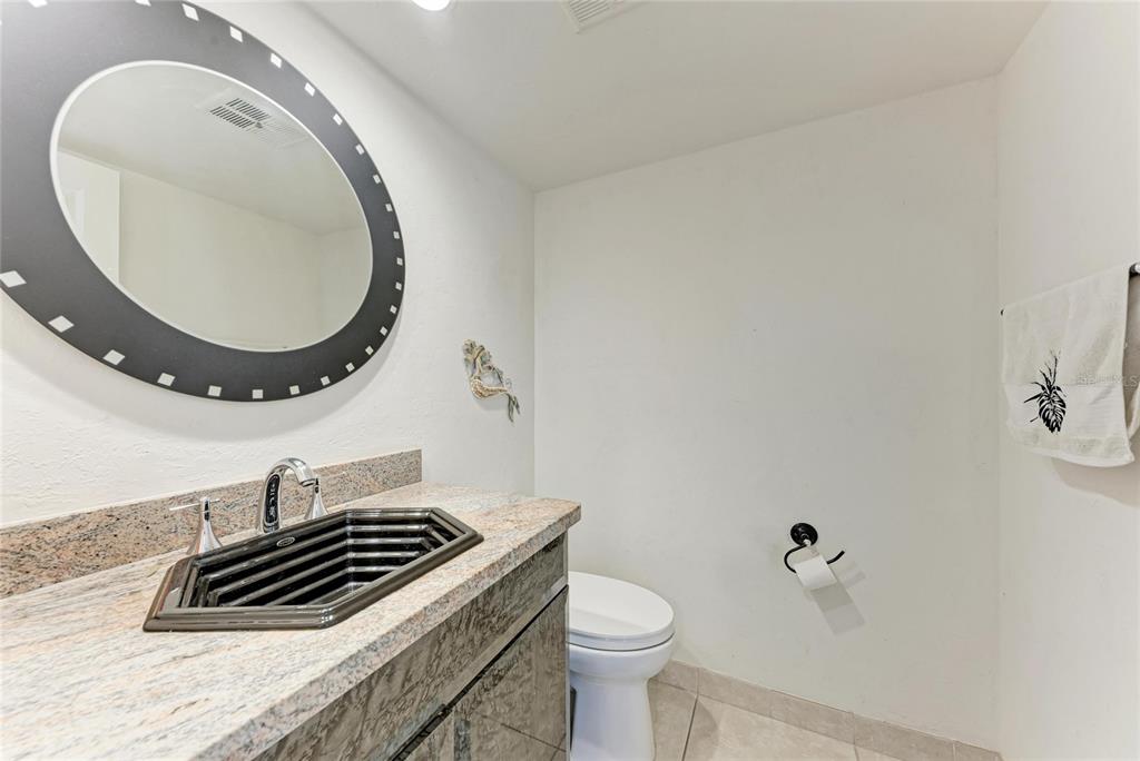 3291 Bayou Road Longboat Key, FL 34228 - Photo 21 of 41 a bathroom with a sink a mirror and a toilet