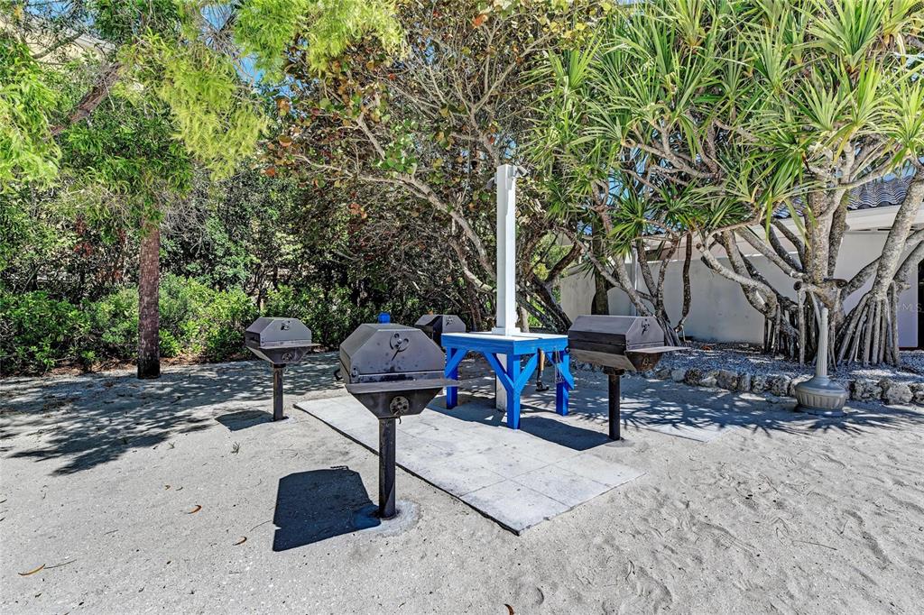 3291 Bayou Road Longboat Key, FL 34228 - Photo 32 of 41 a view of backyard with table and chairs and a fire pit