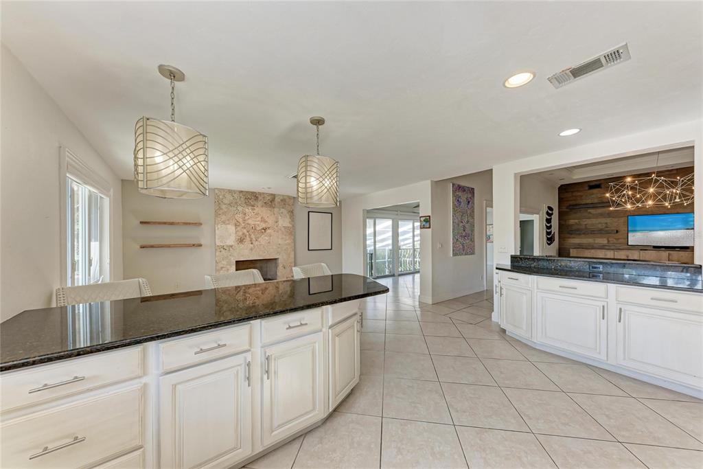 3291 Bayou Road Longboat Key, FL 34228 - Photo 9 of 41 a large kitchen with granite countertop a sink and white cabinets