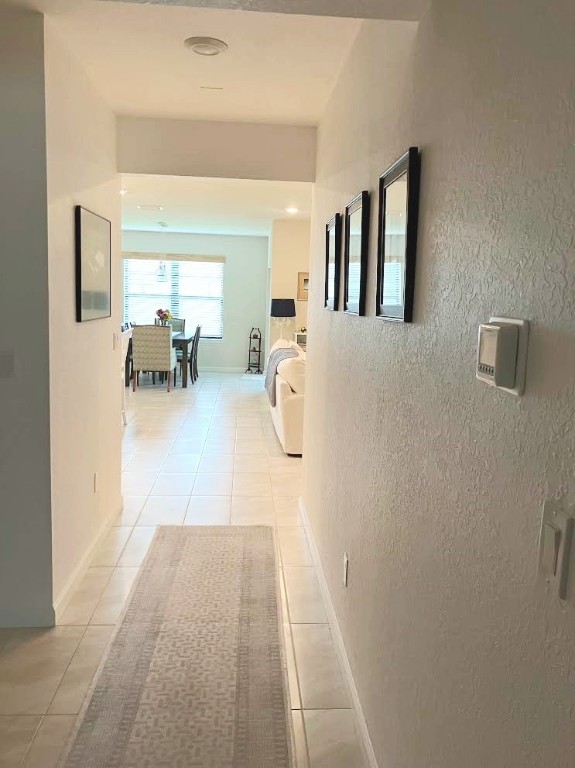 Undisclosed Address Vero Beach, FL 32967 - Photo 3 of 7 a hallway with a couch and chandelier