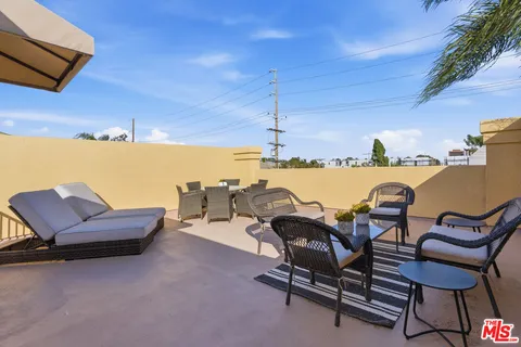 a terrace with outdoor seating and city view