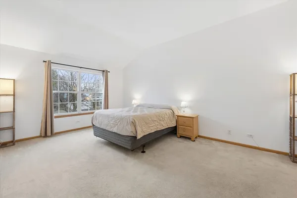 a bedroom with a bed and a table