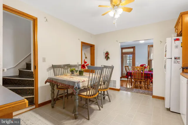 a view of a dining room with furniture and a chandelier