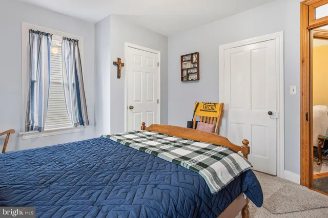 a bedroom with a bed and dresser