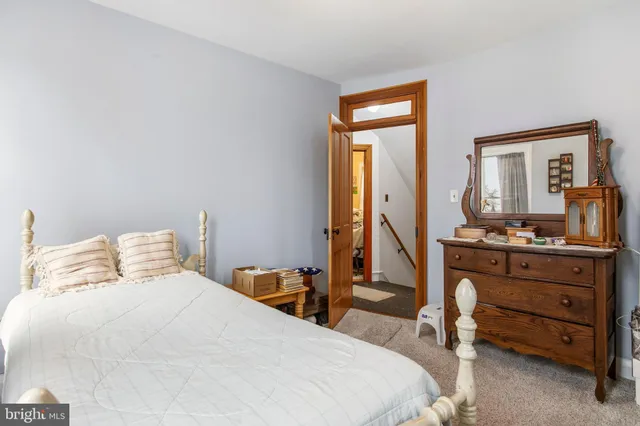 a living room with furniture and a mirror