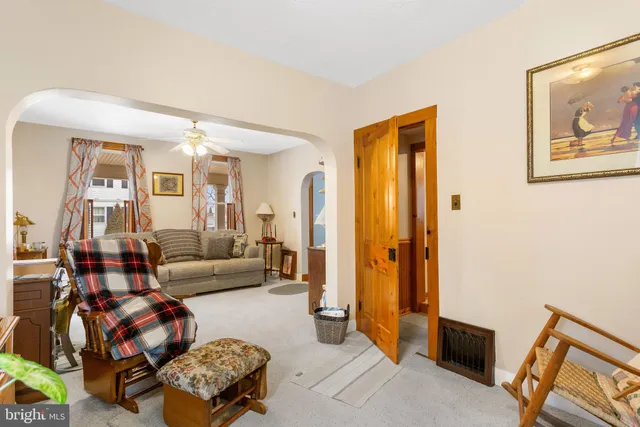 a living room with furniture and a painting on the wall