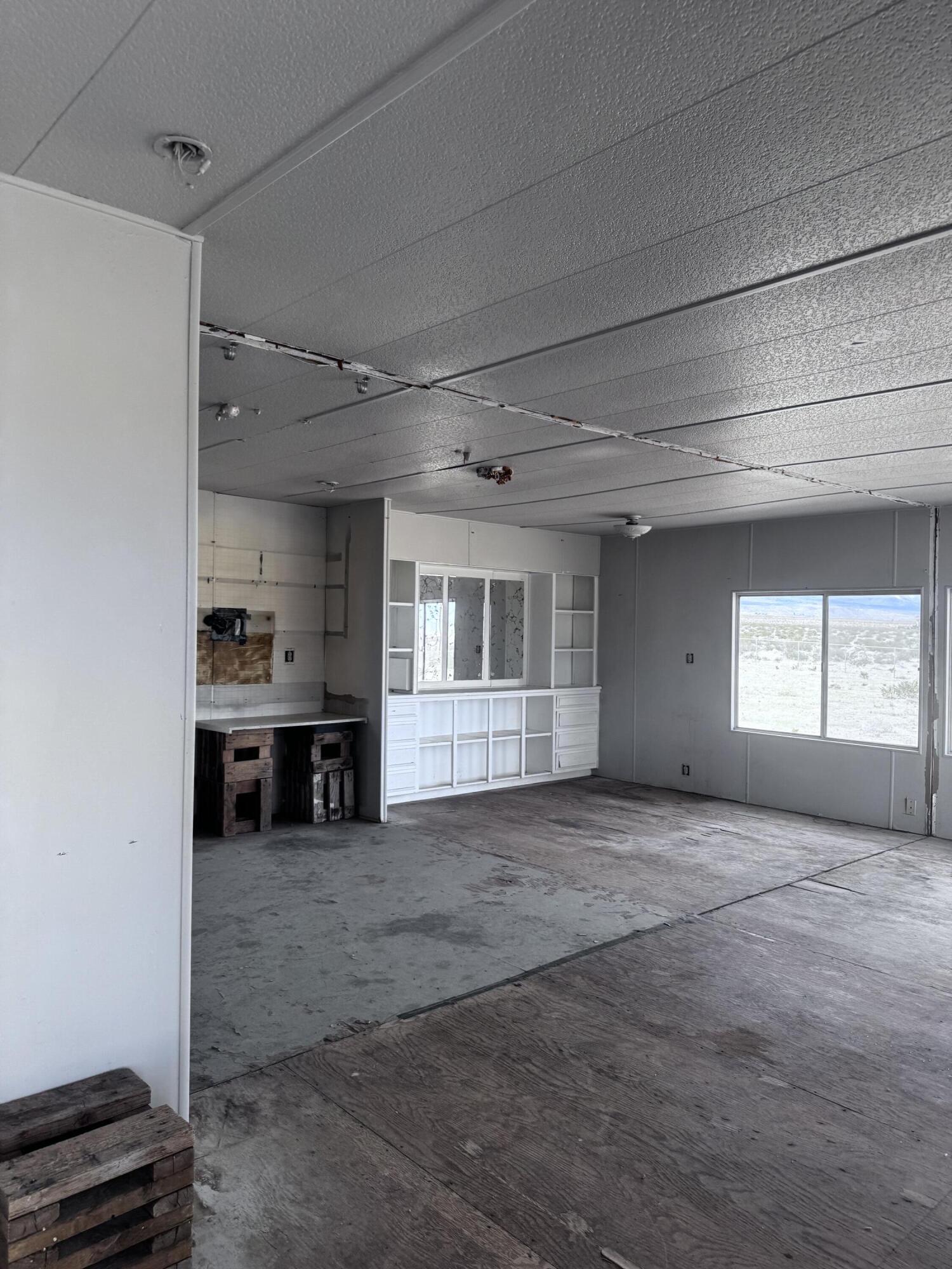 3 Foothill Road Lucerne Valley, CA 92356 - Photo 11 of 14 a view of empty room with a fireplace and window