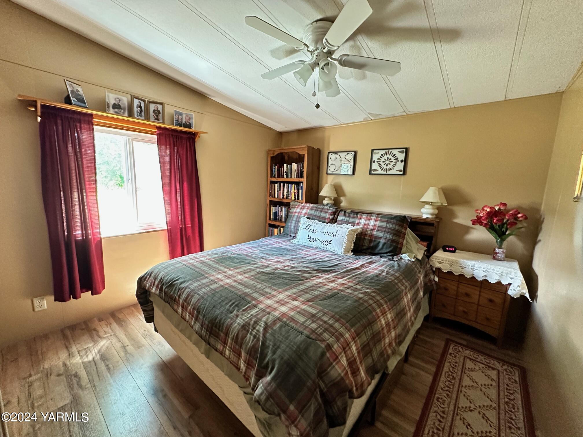 1131 County Line Road Grandview, WA 98930 - Photo 4 of 11 a bedroom with bed and a chandelier