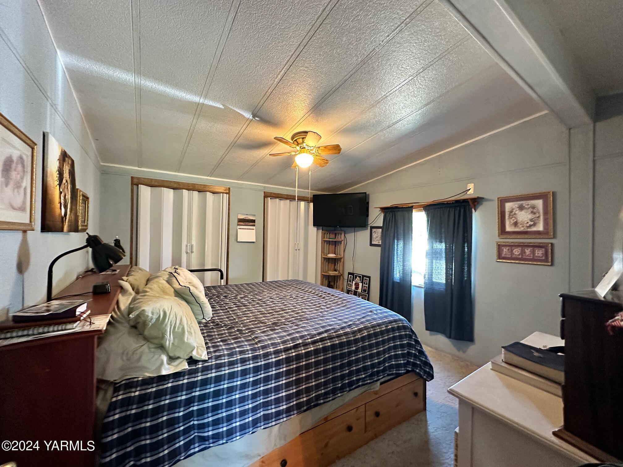 1131 County Line Road Grandview, WA 98930 - Photo 8 of 11 a bedroom with a bed and a chandelier