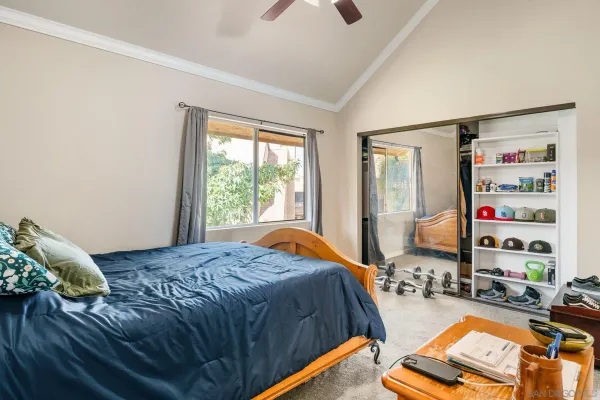 a bed sitting in a bedroom next to a window