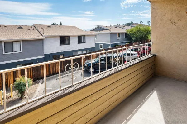 a balcony with stainless steel appliances kitchen island granite countertop a large window
