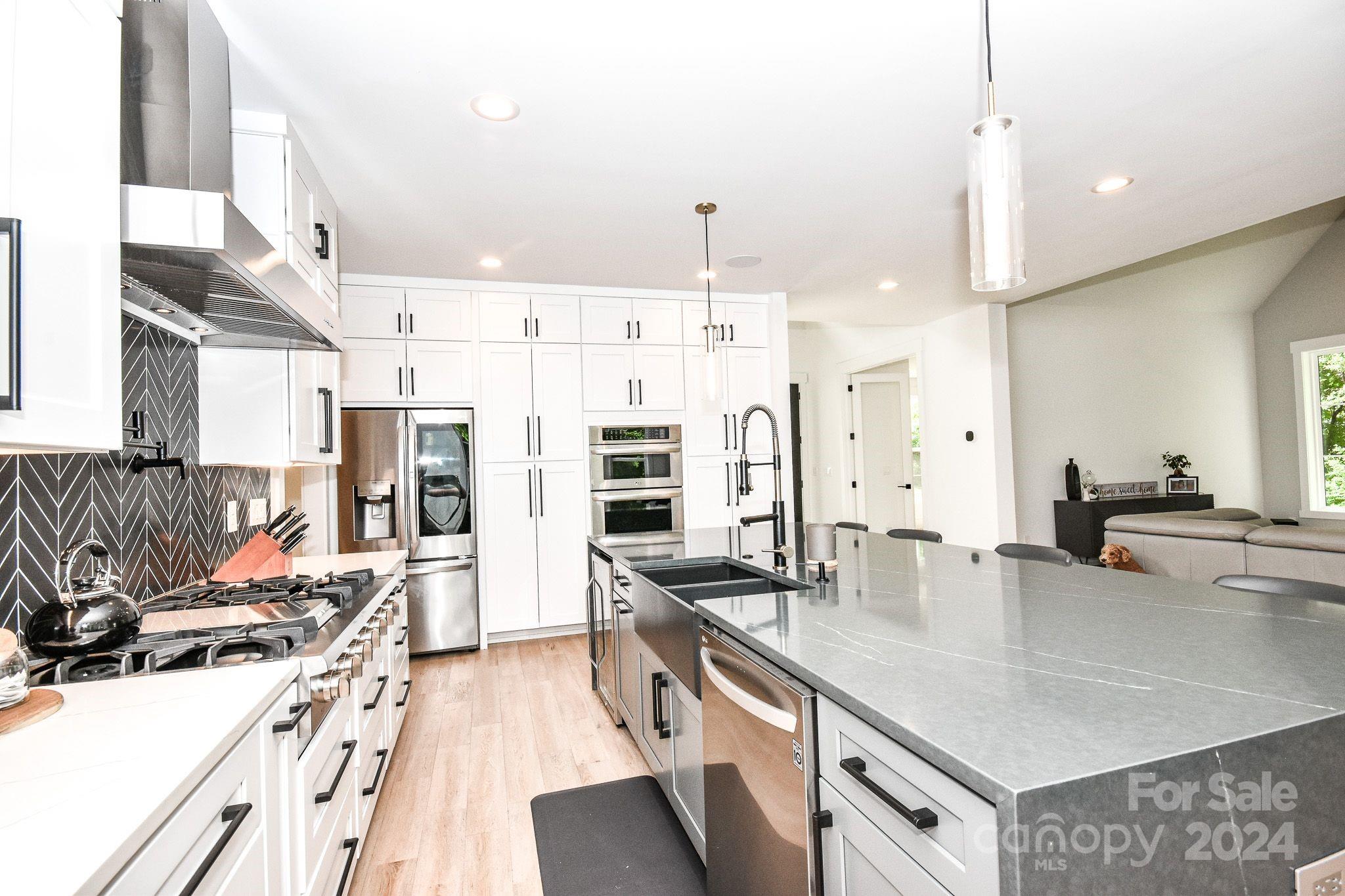 322 Mountainview Drive Charlotte, NC 28270 - Photo 13 of 47 a kitchen with stainless steel appliances granite countertop a sink stove and refrigerator
