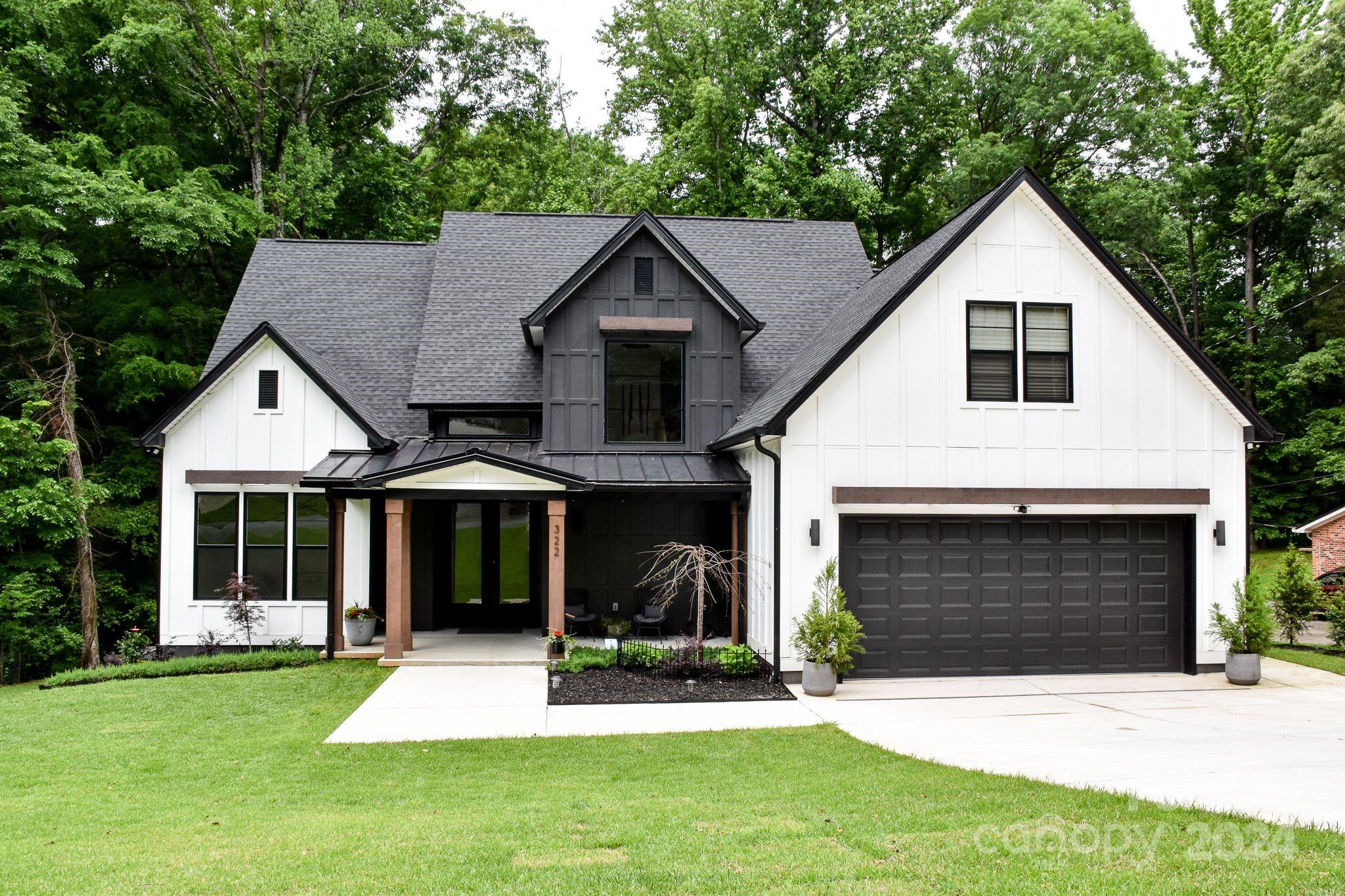 322 Mountainview Drive Charlotte, NC 28270 - Photo 2 of 47 a front view of a house with a yard and garage