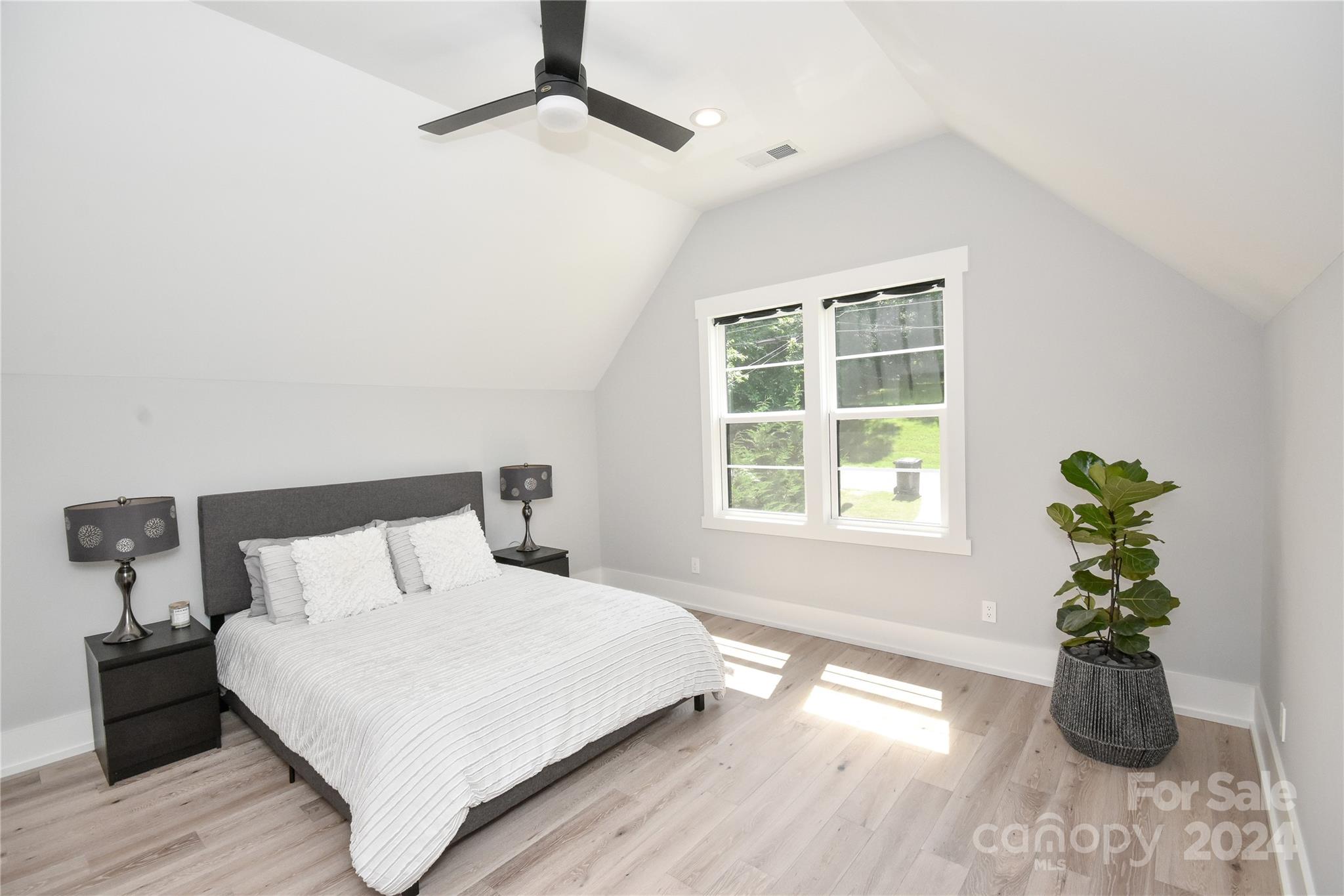 322 Mountainview Drive Charlotte, NC 28270 - Photo 32 of 47 a bedroom with a bed and a potted plant