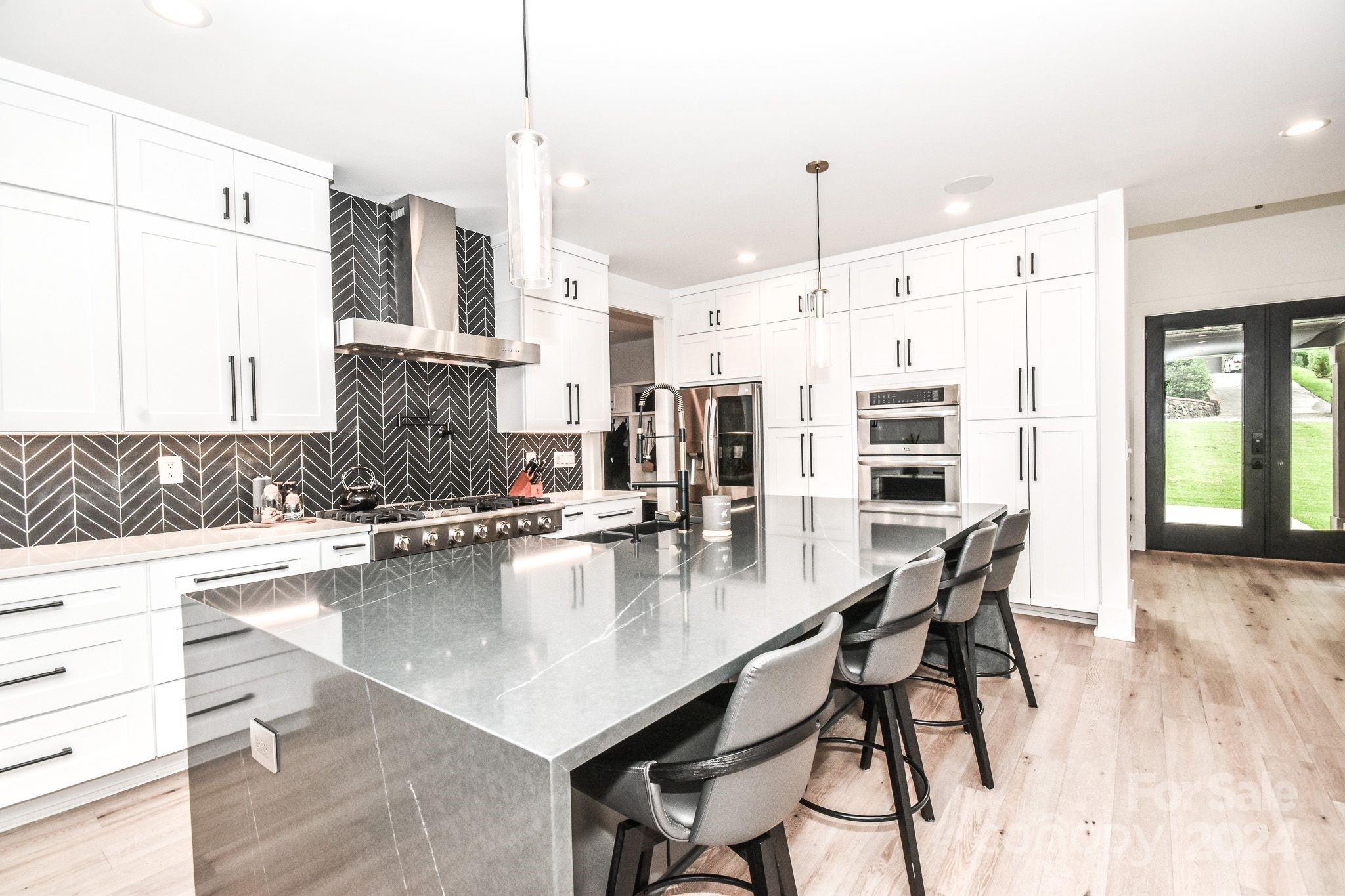 322 Mountainview Drive Charlotte, NC 28270 - Photo 10 of 47 a kitchen with stainless steel appliances granite countertop a stove top oven a sink a counter space and dining table