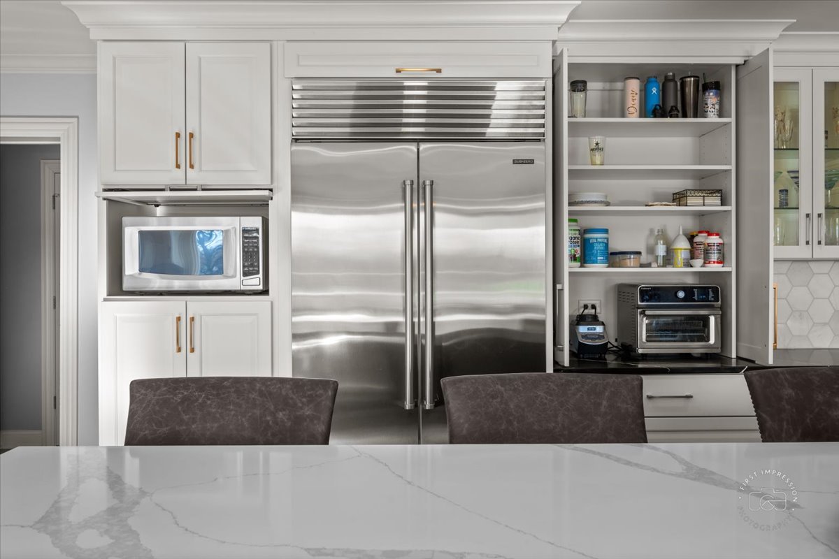 958 West Bauer Road Naperville, IL 60563 - Photo 16 of 57 a kitchen with kitchen island a counter top a refrigerator and cabinets
