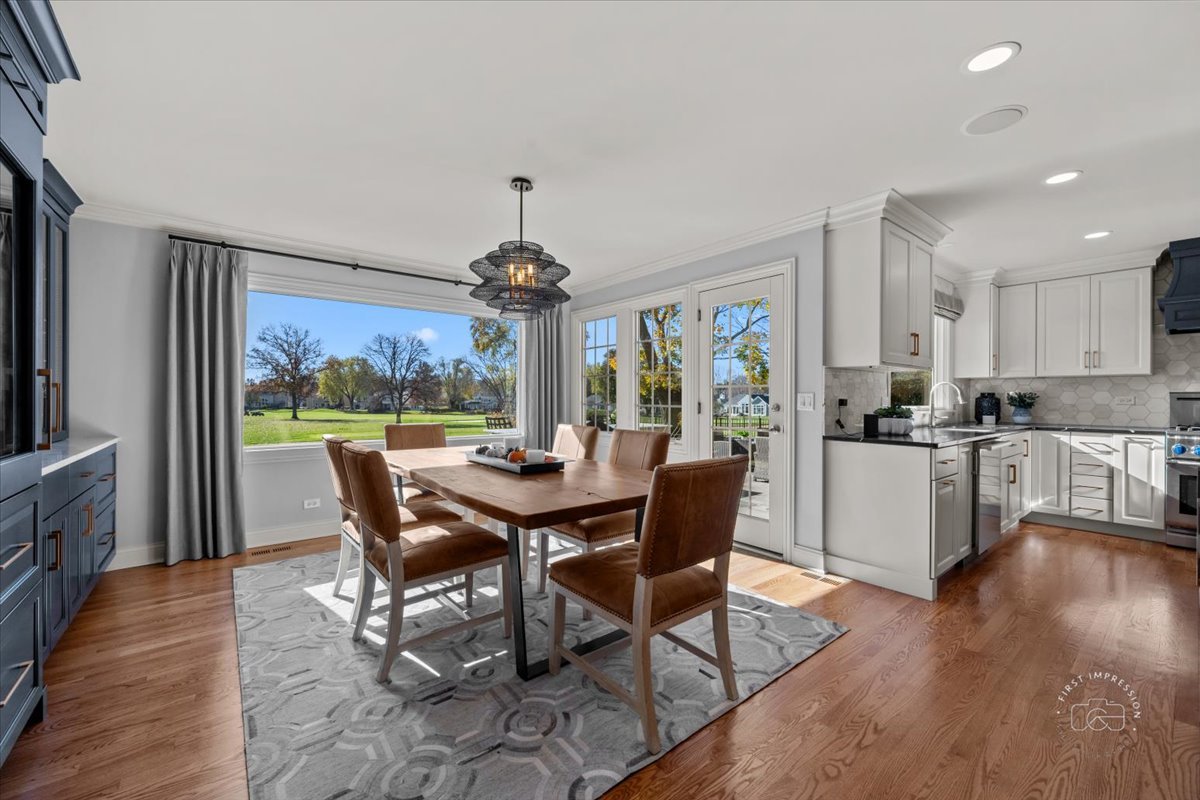 958 West Bauer Road Naperville, IL 60563 - Photo 19 of 57 a view of a dining room with furniture a chandelier and wooden floor