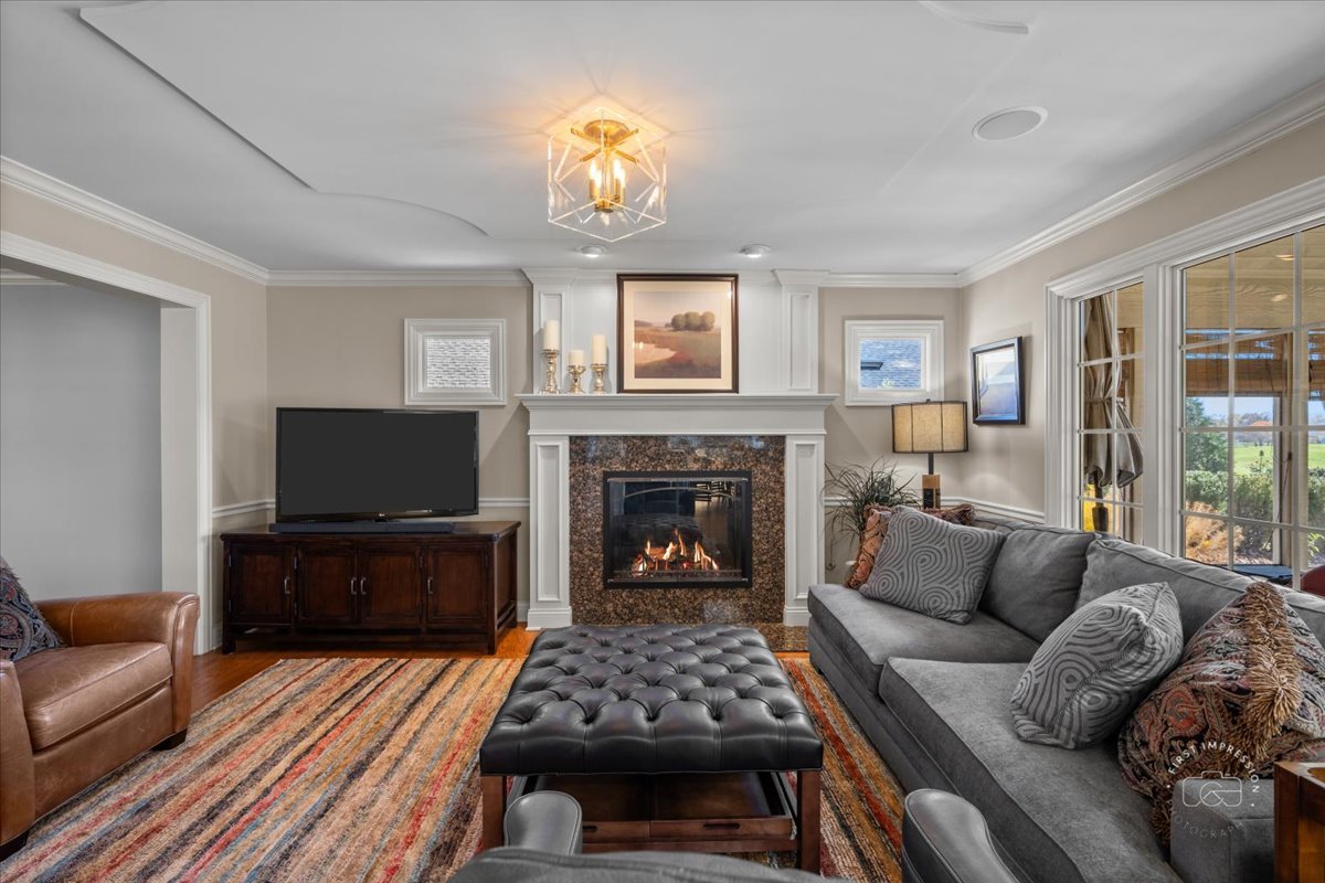 958 West Bauer Road Naperville, IL 60563 - Photo 26 of 57 a living room with furniture a fireplace and a flat screen tv