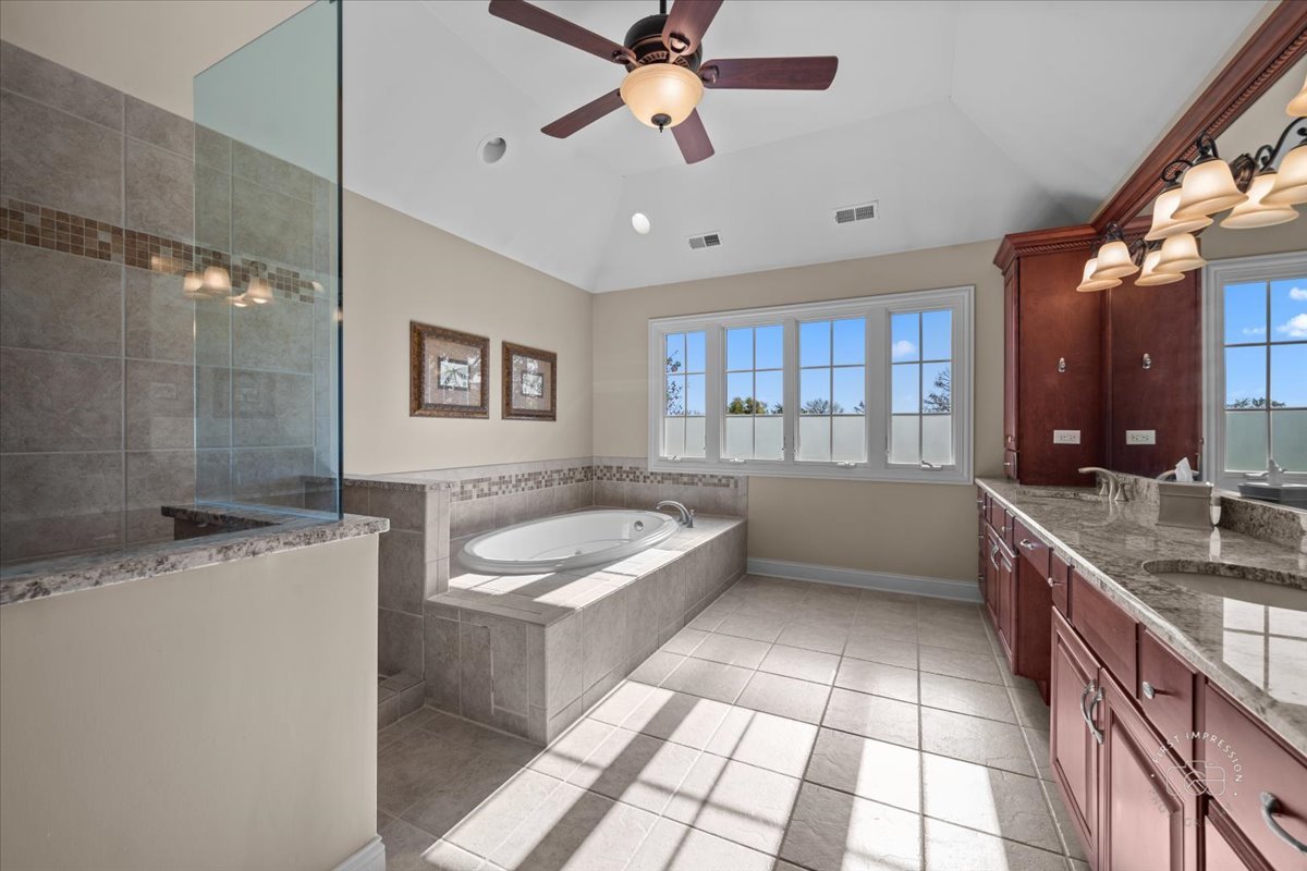 958 West Bauer Road Naperville, IL 60563 - Photo 38 of 57 a bathroom with a granite countertop sink a toilet a mirror and bathtub