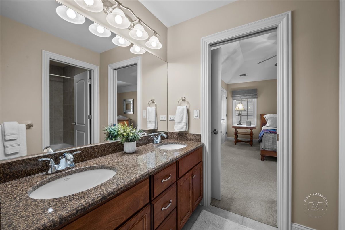 958 West Bauer Road Naperville, IL 60563 - Photo 42 of 57 a en suite bathroom with a granite countertop double vanity sink and a mirror