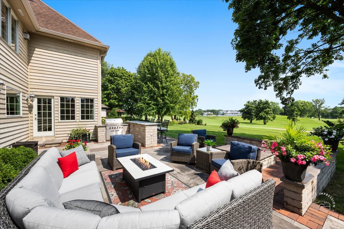 958 West Bauer Road Naperville, IL 60563 - Photo 50 of 57 a view of a patio with couches potted plants and a big yard