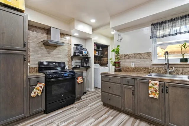 a kitchen with stainless steel appliances granite countertop a stove and a sink