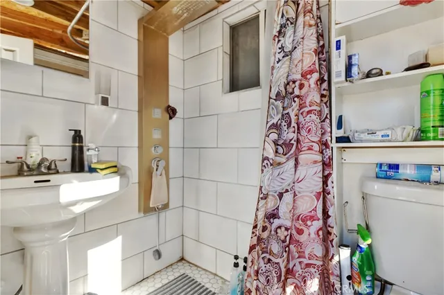 a bathroom with a sink toilet and shower