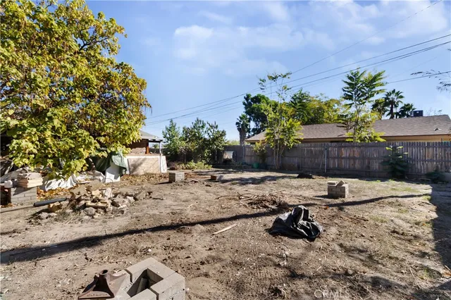 a view of a backyard with furniture and plants