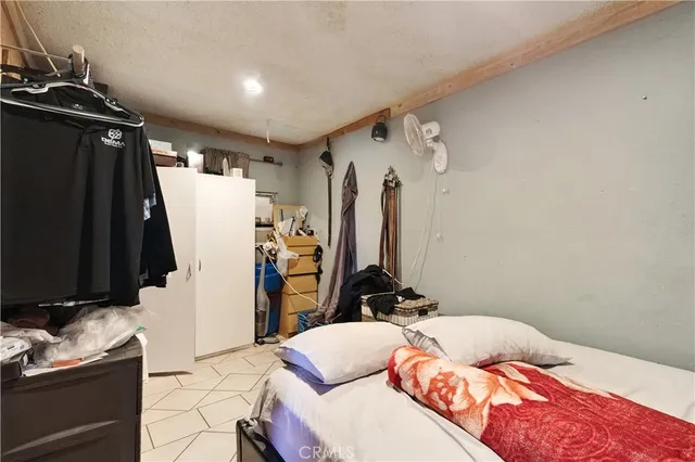 a bedroom with a bed and a mirror