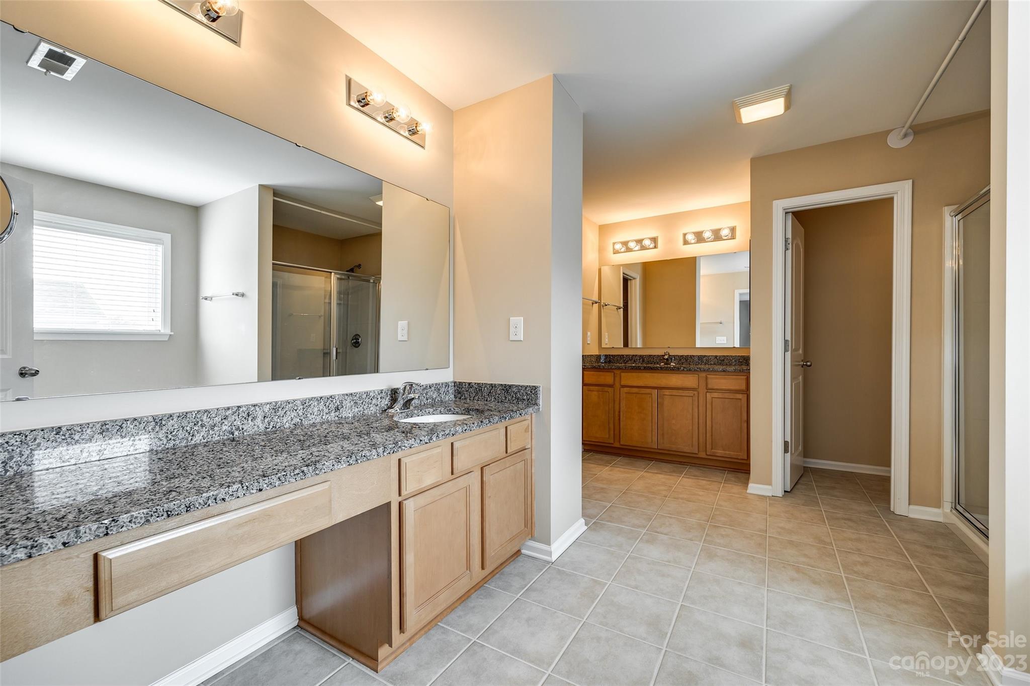8055 Bryson Road Indian Land, SC 29707 - Photo 17 of 45 a bathroom with a granite countertop sink and a mirror
