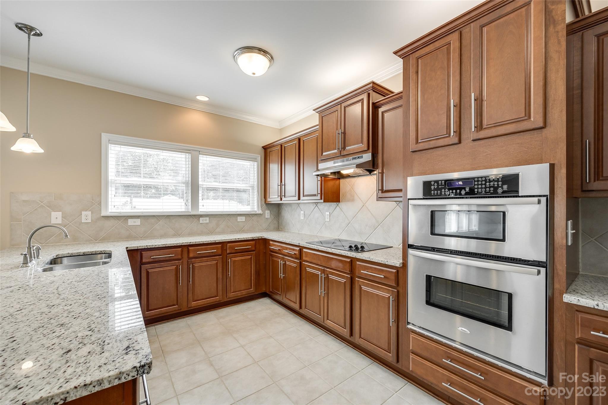 8055 Bryson Road Indian Land, SC 29707 - Photo 7 of 45 a kitchen with granite countertop stainless steel appliances sink and cabinets