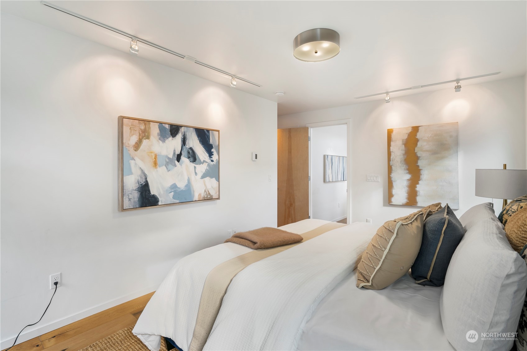 1122 23rd Avenue South, Unit C Seattle, WA 98144 - Photo 16 of 27 a bedroom with a bed and a painting on the wall