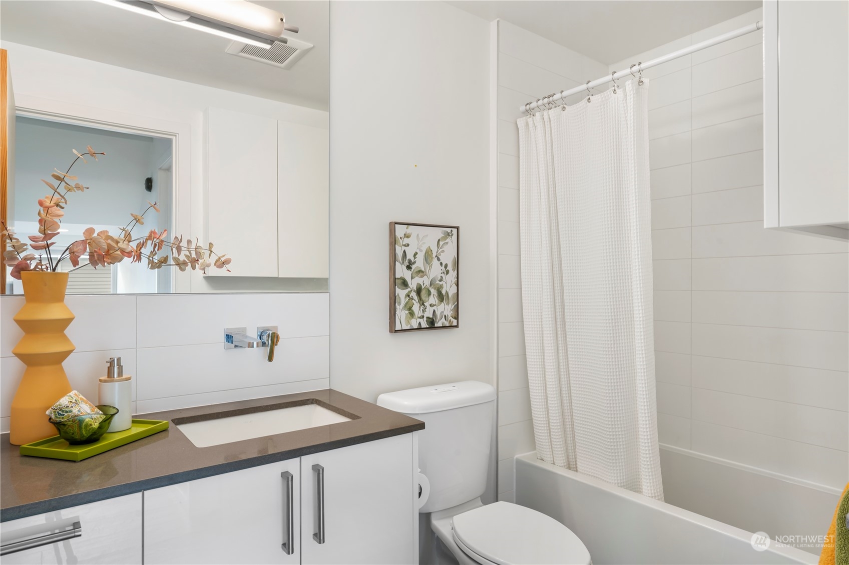 1122 23rd Avenue South, Unit C Seattle, WA 98144 - Photo 20 of 27 a bathroom with a sink a toilet and shower curtain