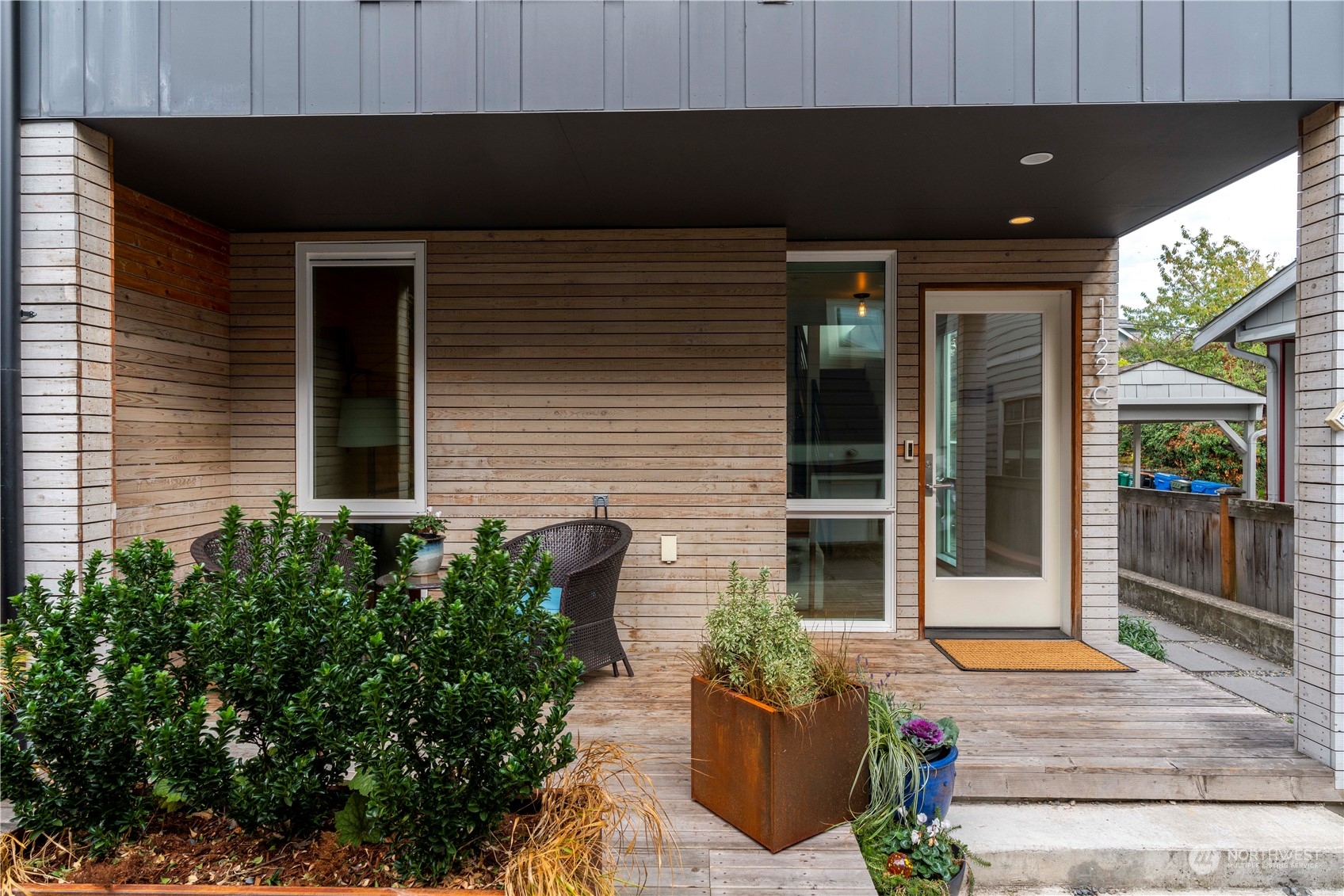1122 23rd Avenue South, Unit C Seattle, WA 98144 - Photo 26 of 27 a front view of a house with potted plants