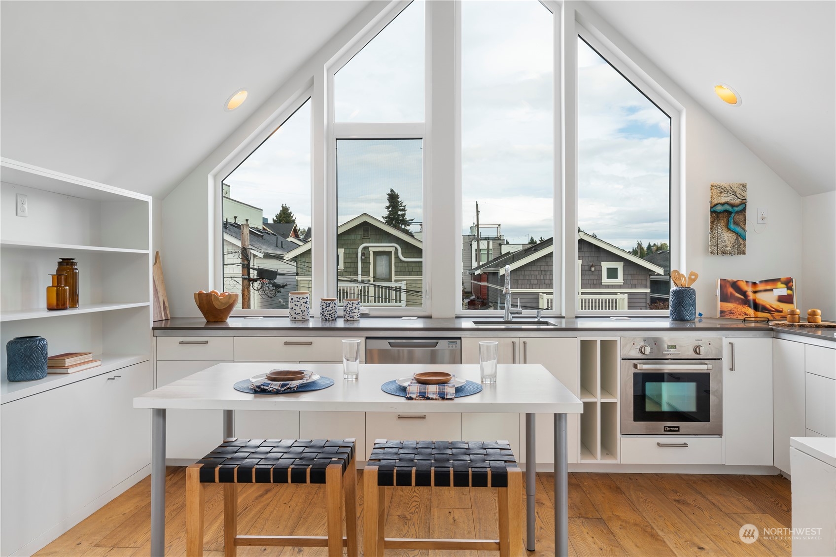 1122 23rd Avenue South, Unit C Seattle, WA 98144 - Photo 8 of 27 a kitchen with stainless steel appliances granite countertop a stove a sink and a microwave