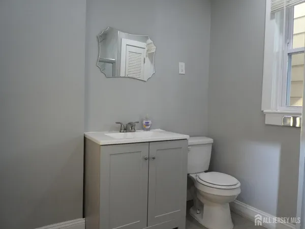 a bathroom with a sink mirror and toilet