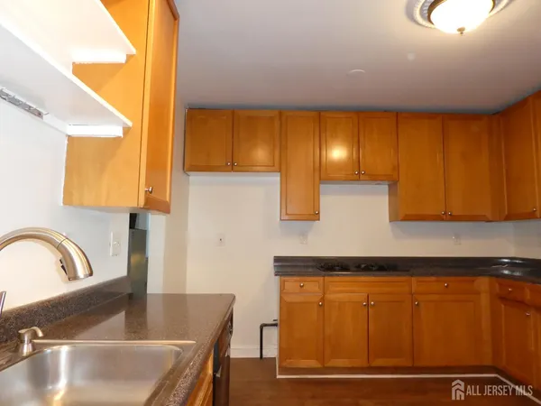a kitchen with granite countertop a sink and cabinets
