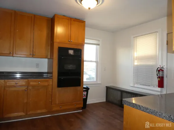 a kitchen with granite countertop cabinets and black stainless steel appliances