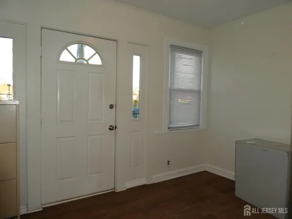 an empty room with closet and wooden floor