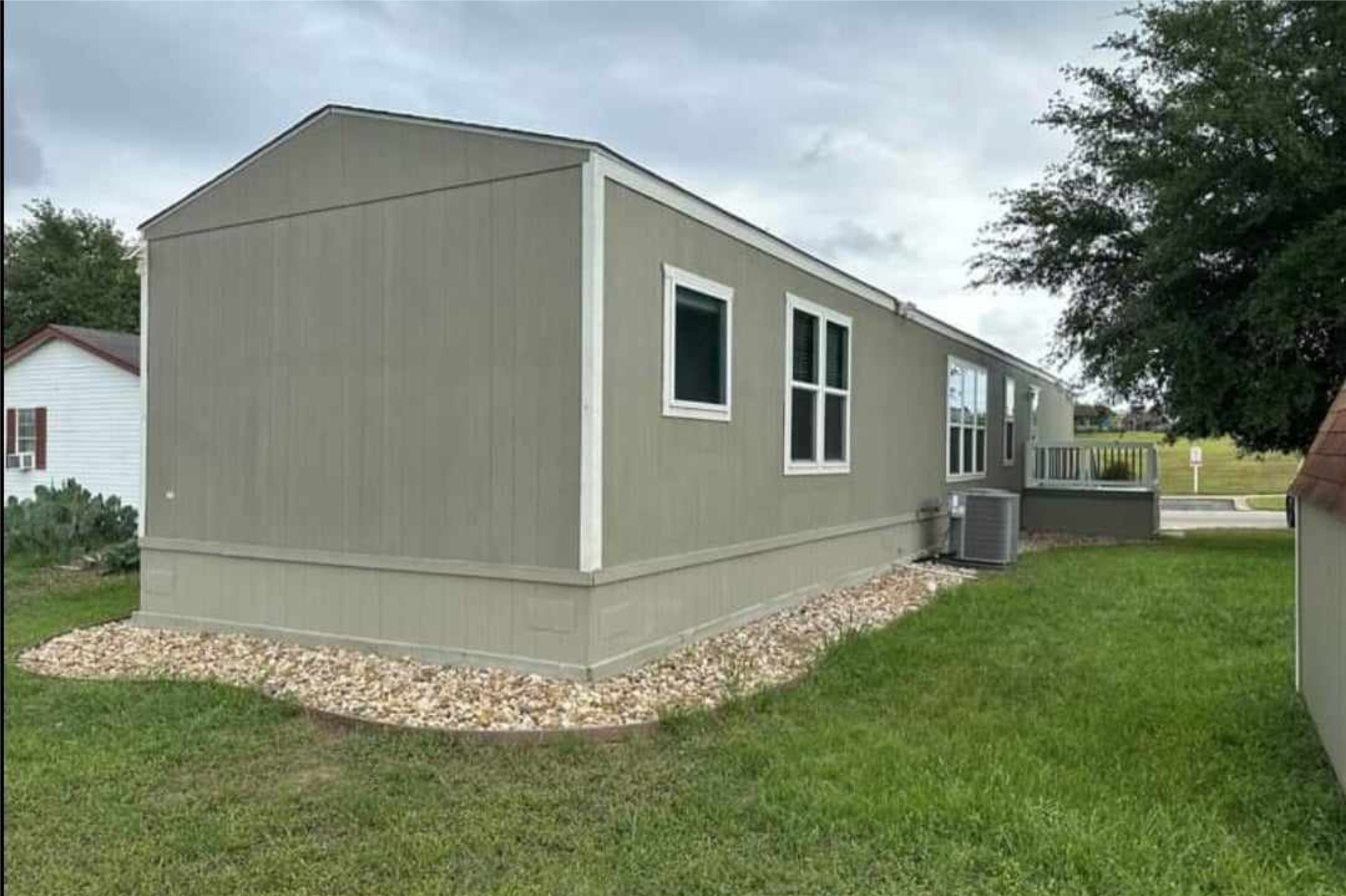 1601 East Slaughter Lane, Unit 464 Austin, TX 78747 - Photo 25 of 26 View of home's exterior featuring a yard and a deck