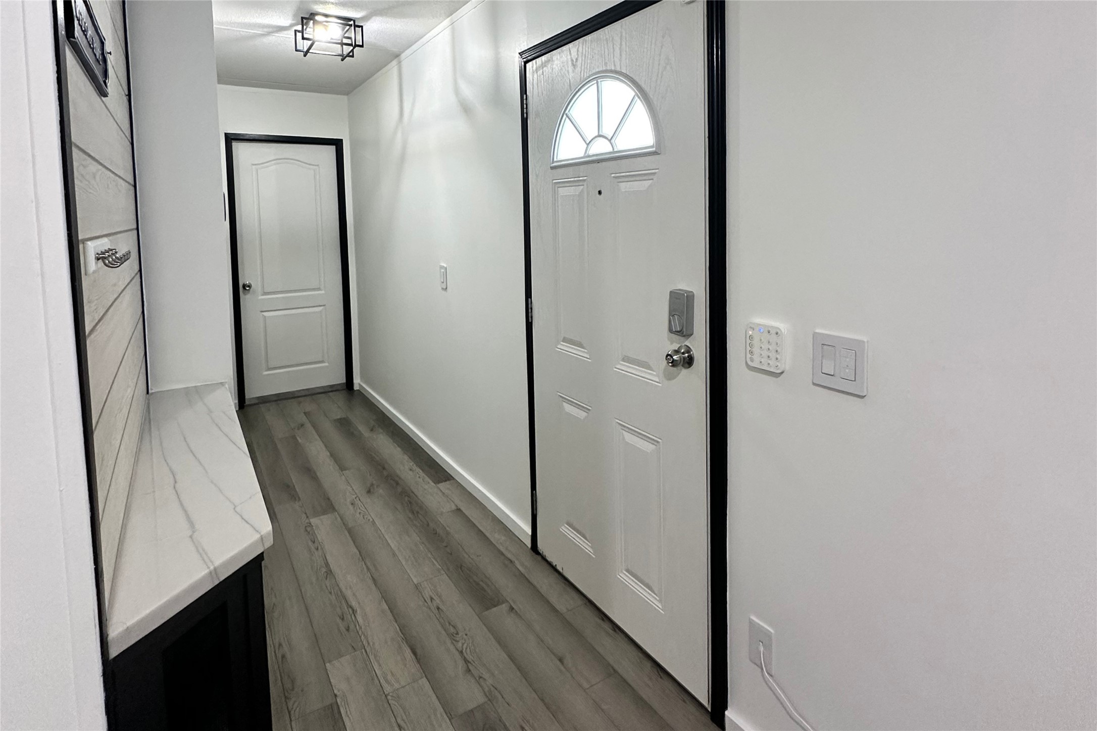 1601 East Slaughter Lane, Unit 464 Austin, TX 78747 - Photo 4 of 26 Doorway with wood finished floors and baseboards