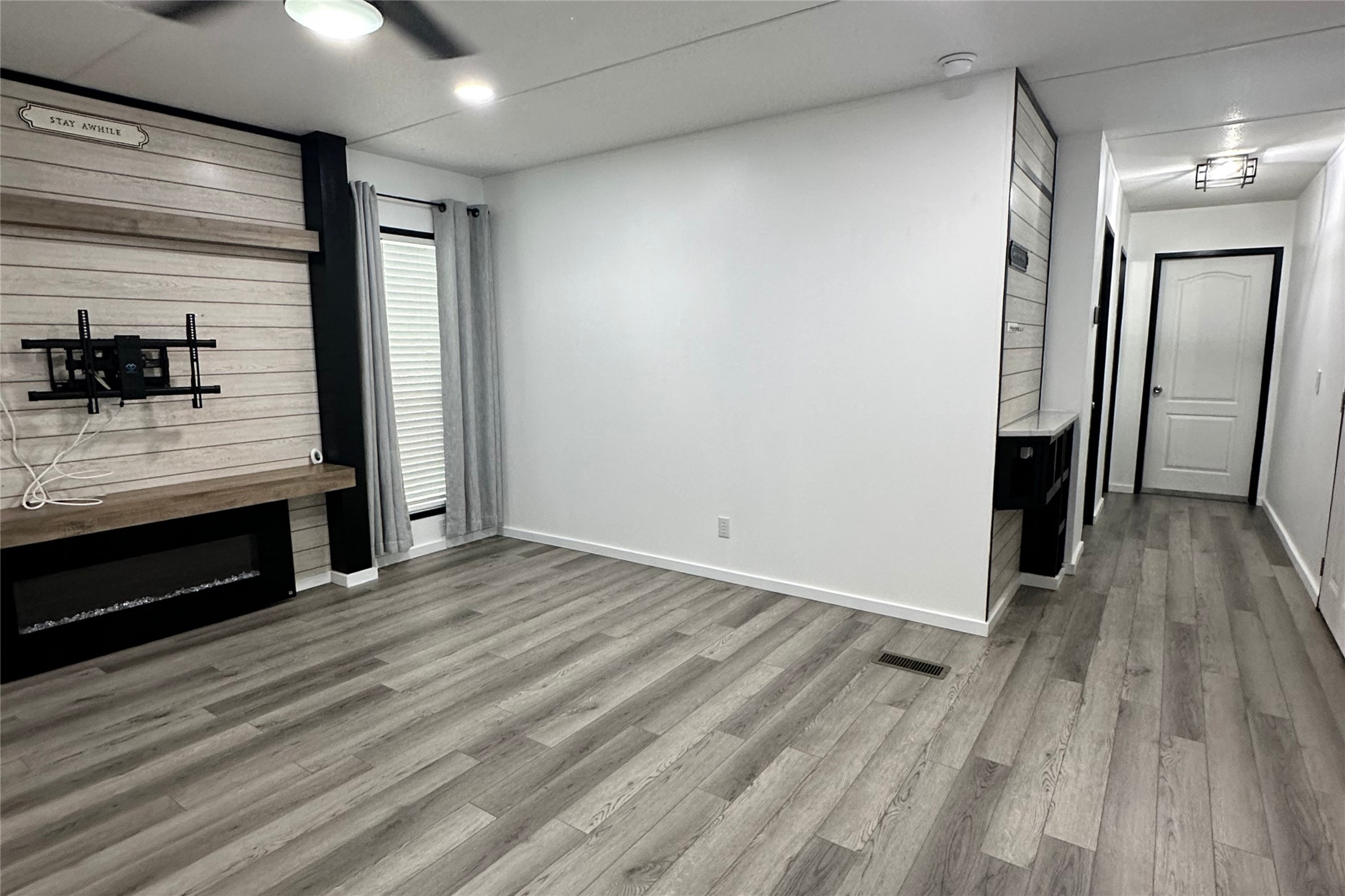 1601 East Slaughter Lane, Unit 464 Austin, TX 78747 - Photo 6 of 26 Unfurnished living room with light wood-style floors and baseboards
