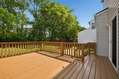 a view of balcony with wooden floor and fence