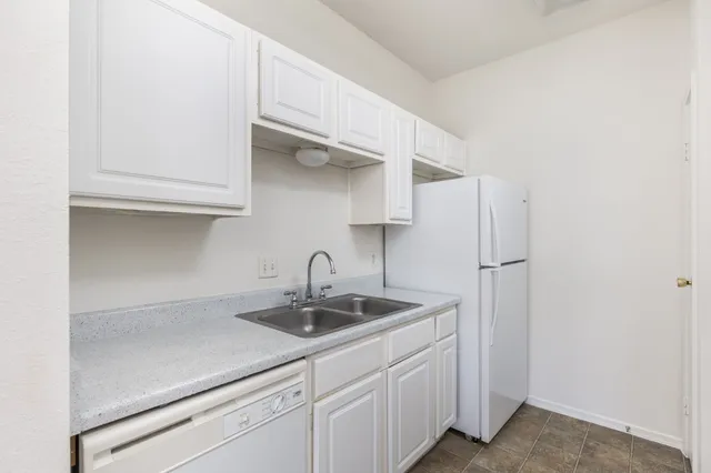 a kitchen with stainless steel appliances a sink and cabinets